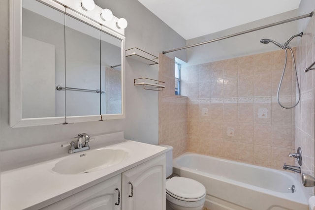 full bathroom with vanity, toilet, and tiled shower / bath combo