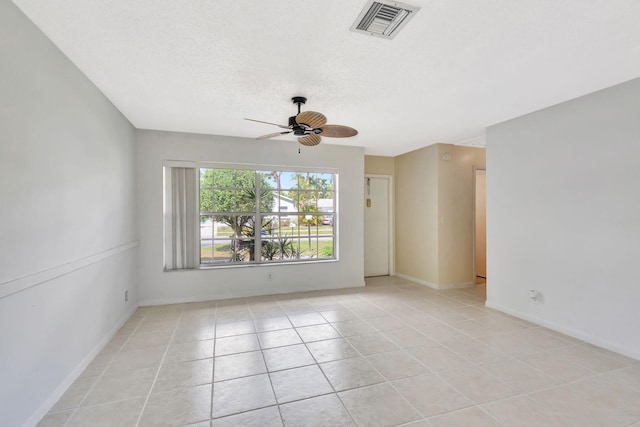 tiled spare room featuring ceiling fan and a textured ceiling