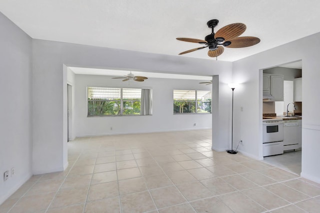 empty room featuring sink, light tile patterned floors, and ceiling fan