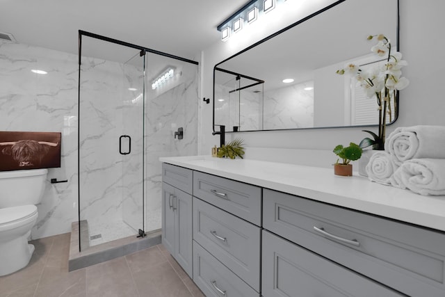 bathroom featuring vanity, toilet, and a shower with shower door