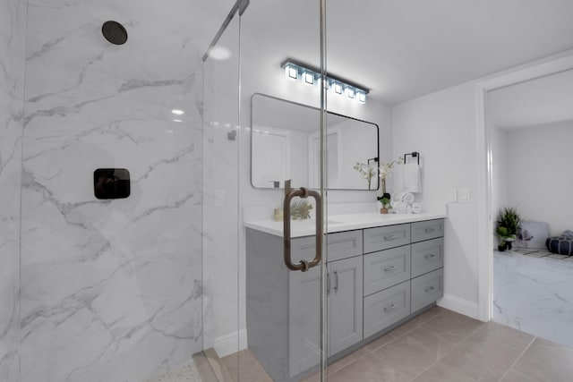 bathroom with vanity and a tile shower