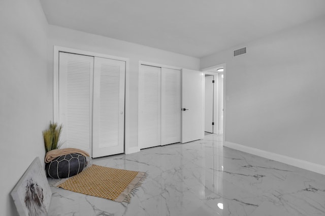 bedroom featuring multiple closets