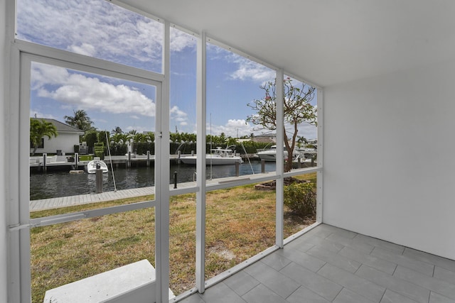 unfurnished sunroom featuring a water view