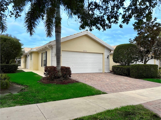 view of side of home with a garage and a lawn