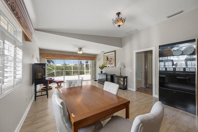 dining room featuring ceiling fan, a textured ceiling, and light wood-type flooring