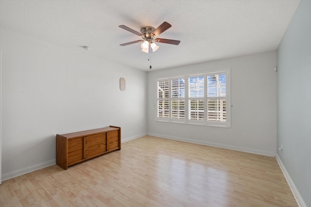 unfurnished room with ceiling fan, a textured ceiling, and light hardwood / wood-style floors