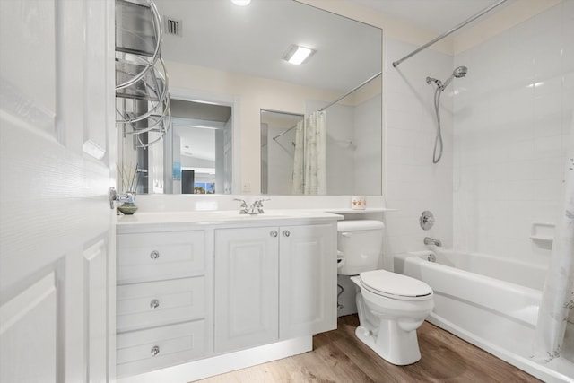 full bathroom featuring shower / tub combo, vanity, wood-type flooring, and toilet