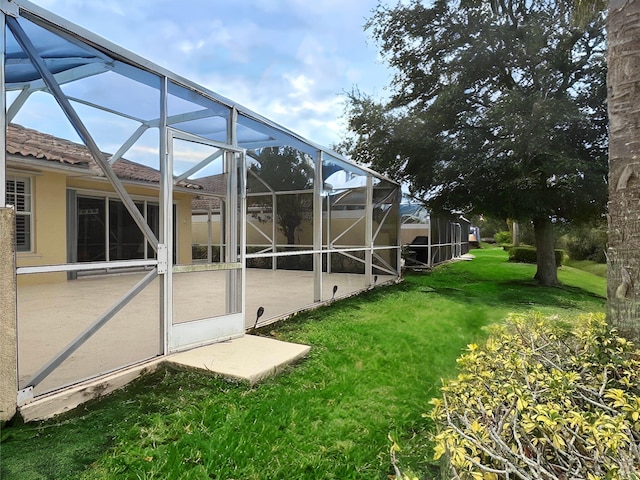 view of yard featuring a patio area and glass enclosure