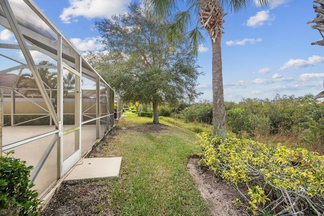 view of yard featuring glass enclosure