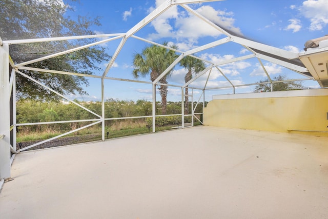 view of patio / terrace featuring glass enclosure