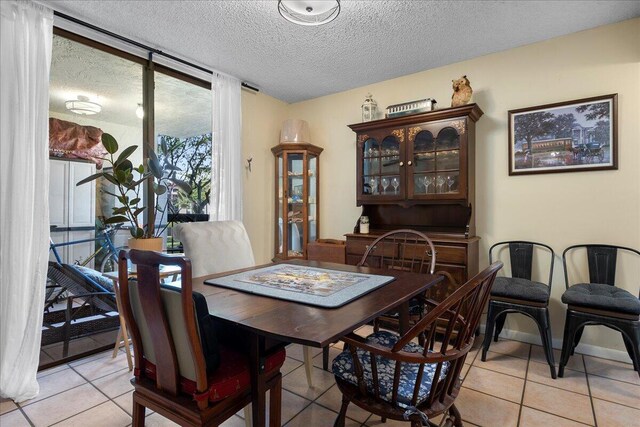 tiled dining area featuring expansive windows and a textured ceiling