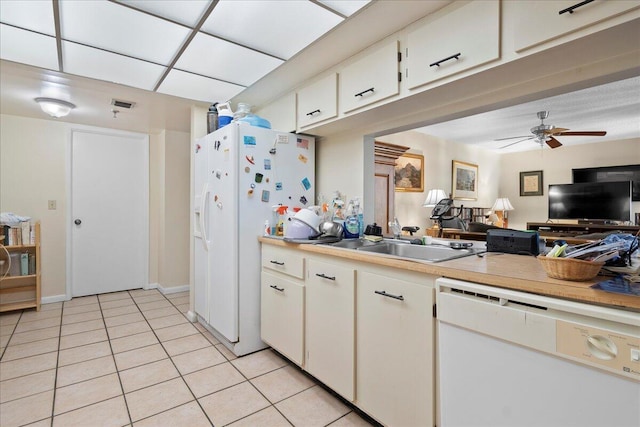 kitchen with sink, white cabinets, light tile patterned floors, ceiling fan, and white appliances