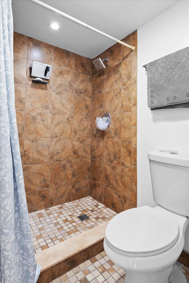 bathroom featuring toilet and walk in shower