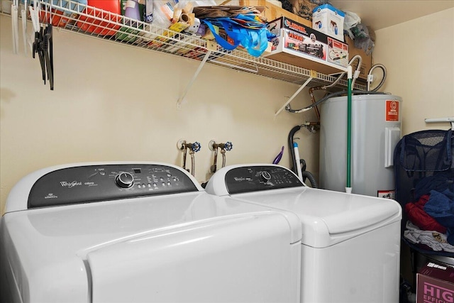 washroom with water heater and independent washer and dryer