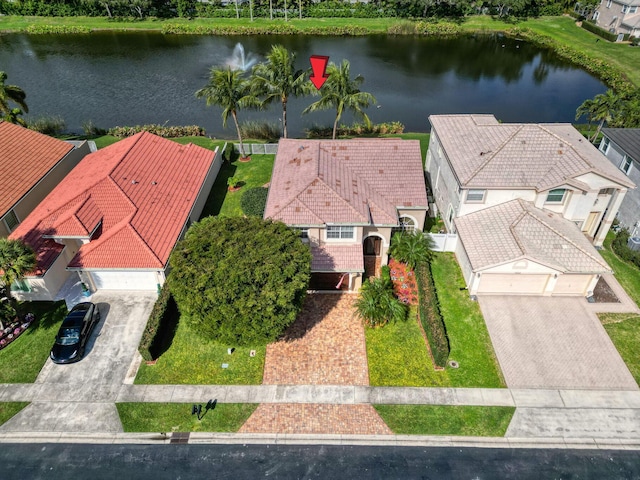 birds eye view of property with a water view