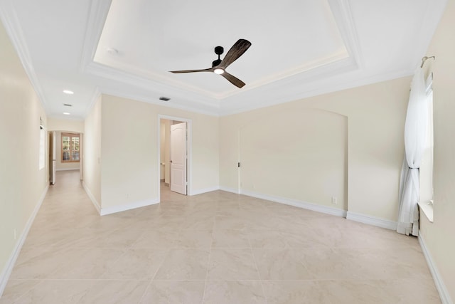 empty room featuring light tile patterned floors, crown molding, a raised ceiling, and ceiling fan