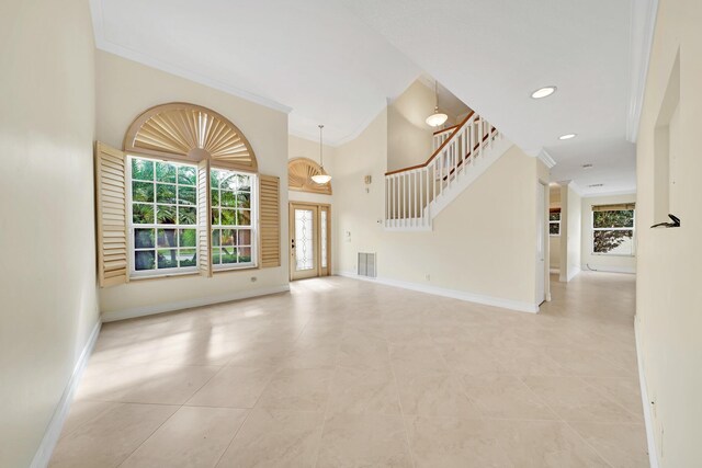 unfurnished living room featuring ornamental molding