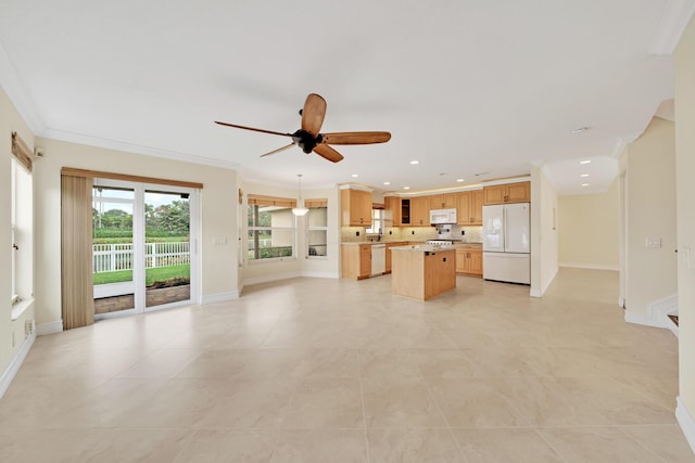 kitchen featuring white appliances, ornamental molding, ceiling fan, and a kitchen island