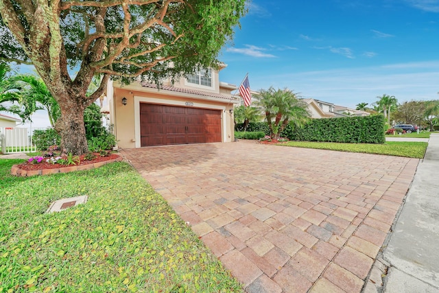 view of front facade featuring a garage and a front lawn