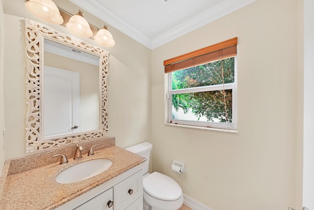 bathroom featuring crown molding, vanity, and toilet