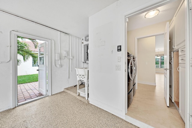 hallway with washer and dryer