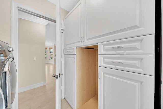 interior space with washer / clothes dryer and white cabinetry