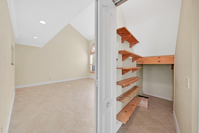 interior space with tile patterned flooring and lofted ceiling