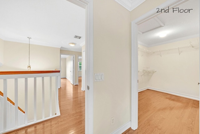 hall with crown molding and hardwood / wood-style floors