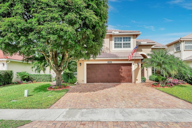 mediterranean / spanish-style home with a garage and a front yard