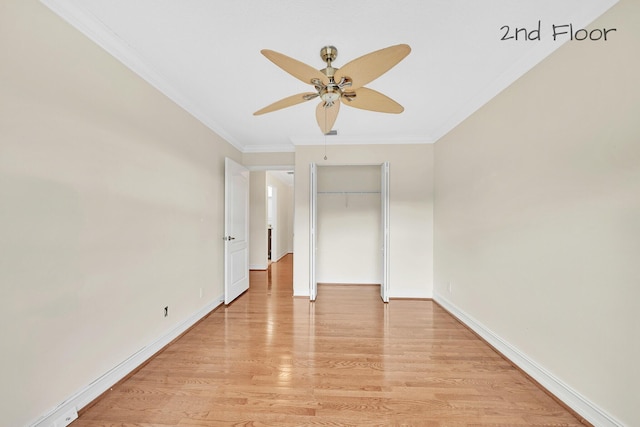 unfurnished bedroom with ornamental molding, a closet, ceiling fan, and light wood-type flooring