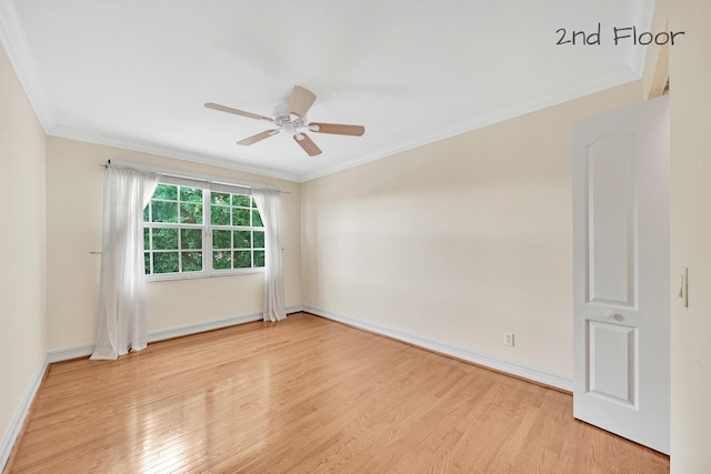 spare room with ornamental molding, ceiling fan, and light wood-type flooring