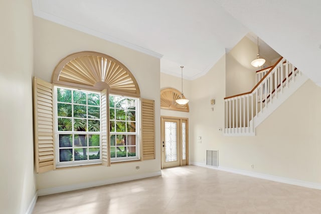 entrance foyer featuring a high ceiling and ornamental molding