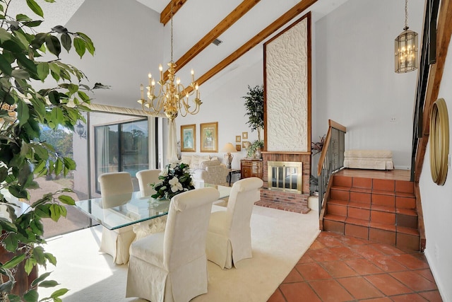 dining space with an inviting chandelier, beam ceiling, high vaulted ceiling, a brick fireplace, and tile patterned floors