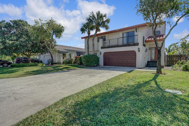 view of front of property featuring a garage, a balcony, and a front yard