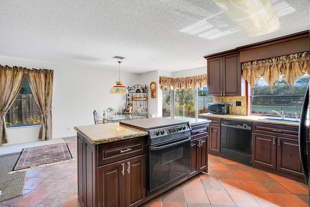 kitchen featuring pendant lighting, backsplash, dark brown cabinets, black appliances, and a kitchen island