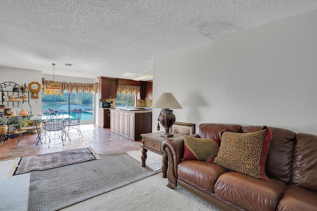 living room featuring a textured ceiling and light tile patterned flooring