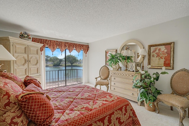 bedroom featuring a water view, light colored carpet, access to exterior, and a textured ceiling