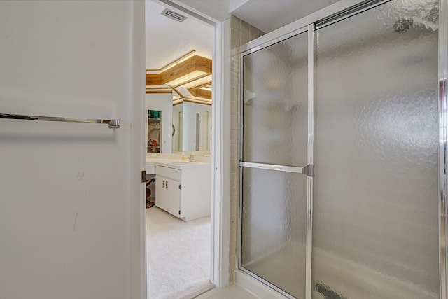 bathroom with vanity and a shower with shower door