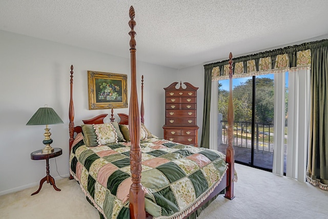 carpeted bedroom with a textured ceiling and access to outside