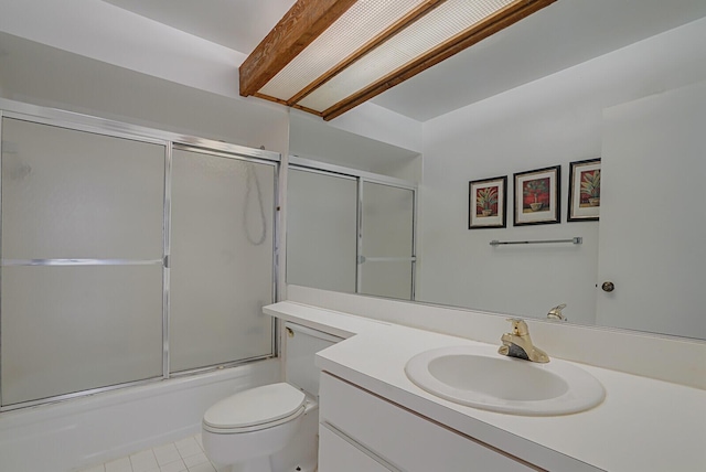 full bathroom featuring vanity, tile patterned flooring, enclosed tub / shower combo, and toilet