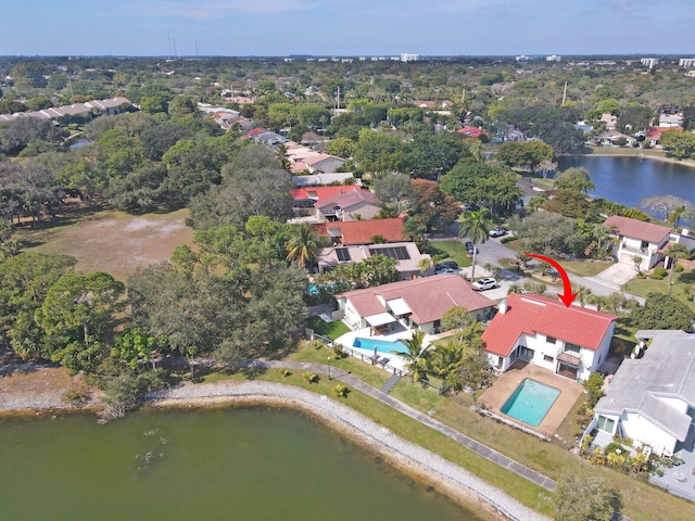 birds eye view of property with a water view