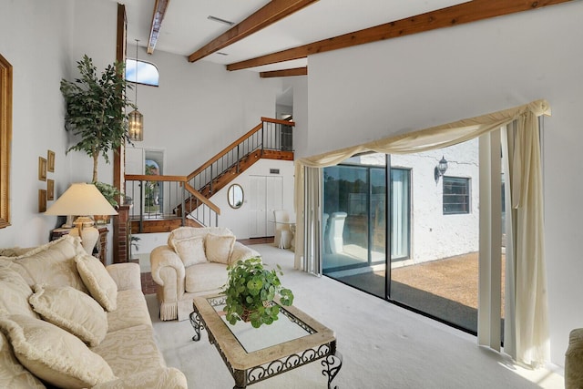 living room featuring beamed ceiling and light colored carpet