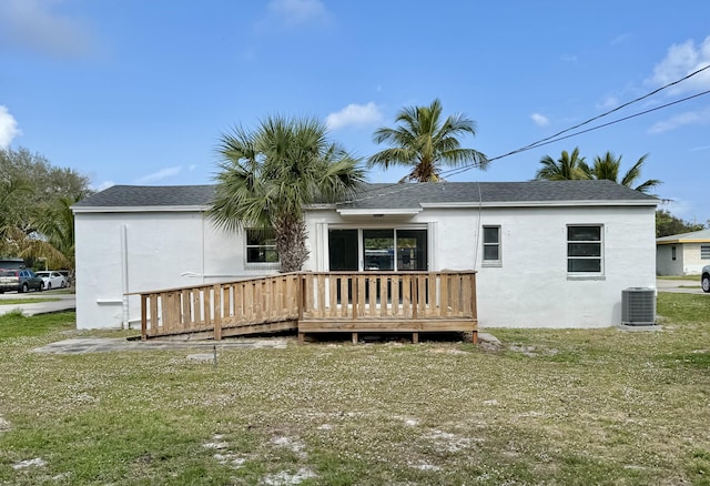 rear view of house featuring a wooden deck, a yard, and central AC unit