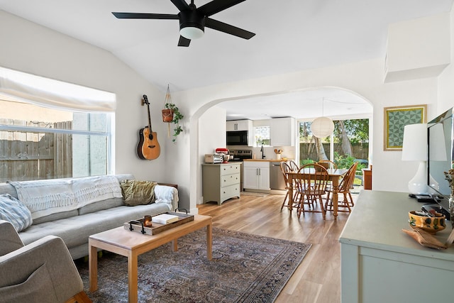 living room with vaulted ceiling, ceiling fan, and light hardwood / wood-style floors