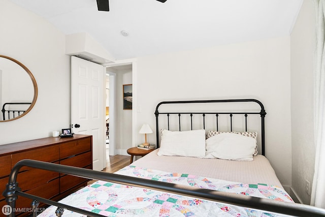 bedroom with wood-type flooring, ceiling fan, and vaulted ceiling