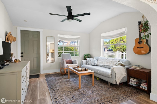 living room with vaulted ceiling, dark hardwood / wood-style floors, and ceiling fan