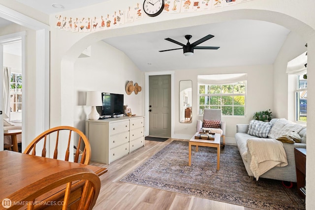 living room with ceiling fan, lofted ceiling, and light wood-type flooring