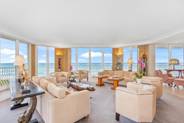 living room with a wealth of natural light, floor to ceiling windows, and a water view