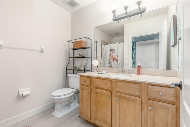 bathroom with vanity, hardwood / wood-style flooring, curtained shower, and toilet