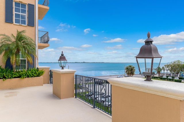 balcony featuring a water view